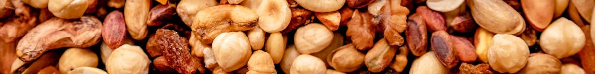 Close-up of assorted nuts and dried fruits creating a colorful, nutritious mix.